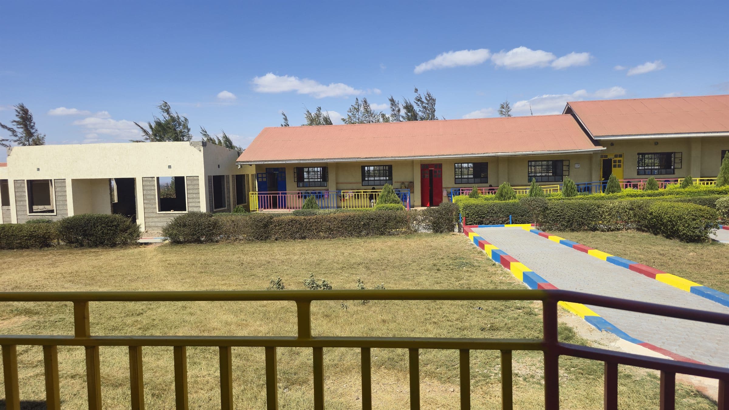 The Oak Leaf Academy campus, showing the classroom block and open playing field.